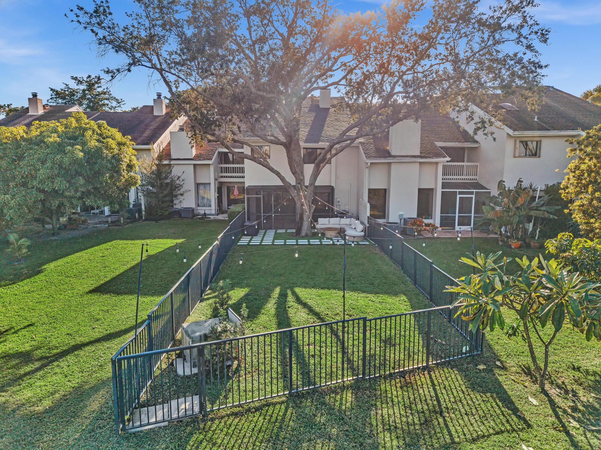 6565 Parkview Drive, Unit C Boca Raton, FL 33433 - Photo 2 of 40 a view of a tennis ground with large trees