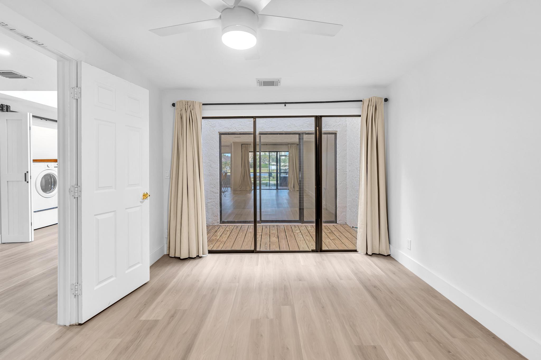 6565 Parkview Drive, Unit C Boca Raton, FL 33433 - Photo 23 of 40 wooden floor in an empty room with a window
