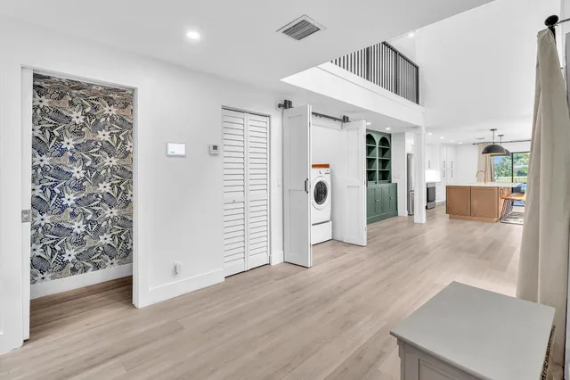 a view of a livingroom with furniture wooden floor and windows
