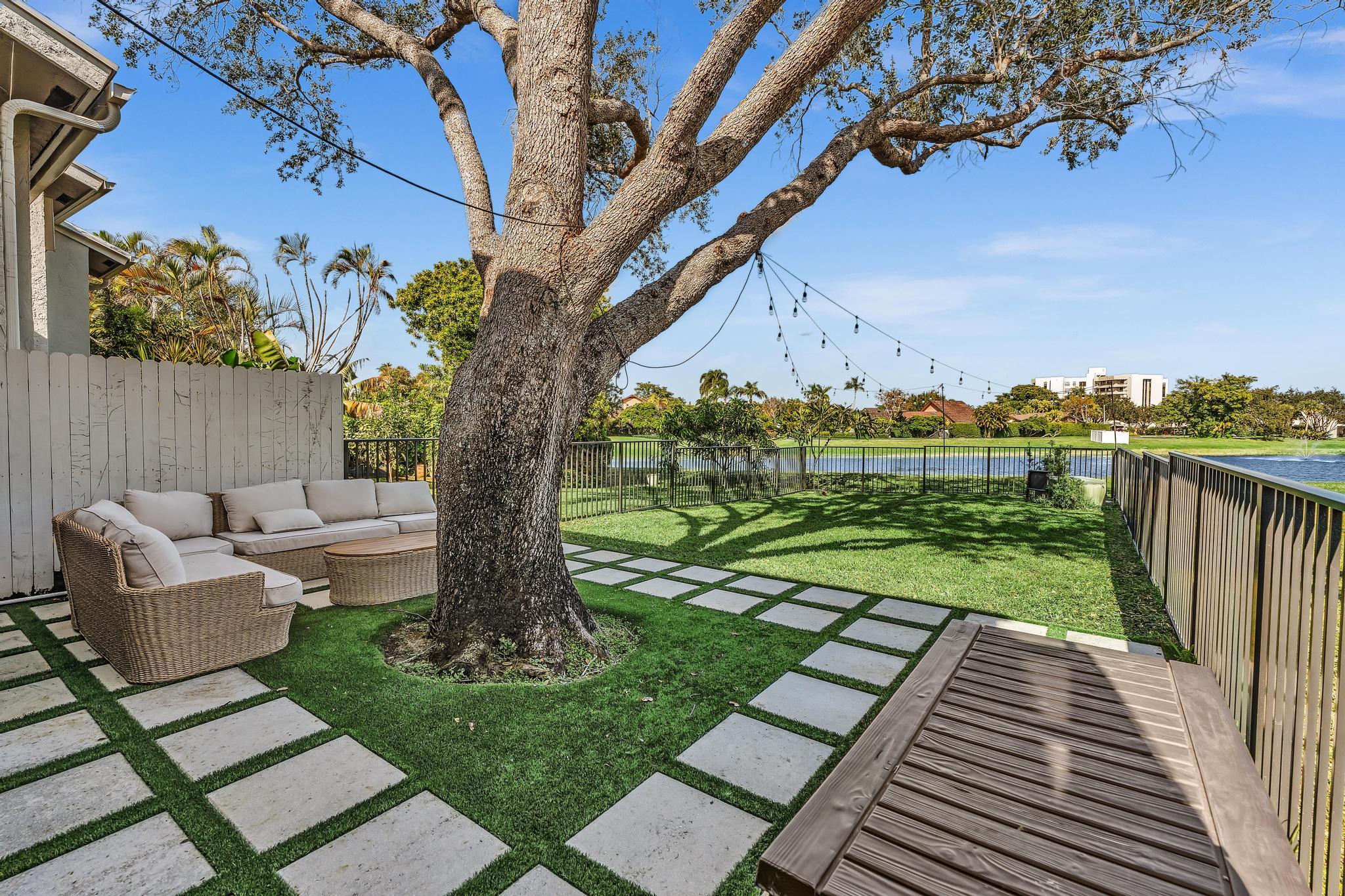 6565 Parkview Drive, Unit C Boca Raton, FL 33433 - Photo 31 of 40 a view of a patio with chairs next to a yard