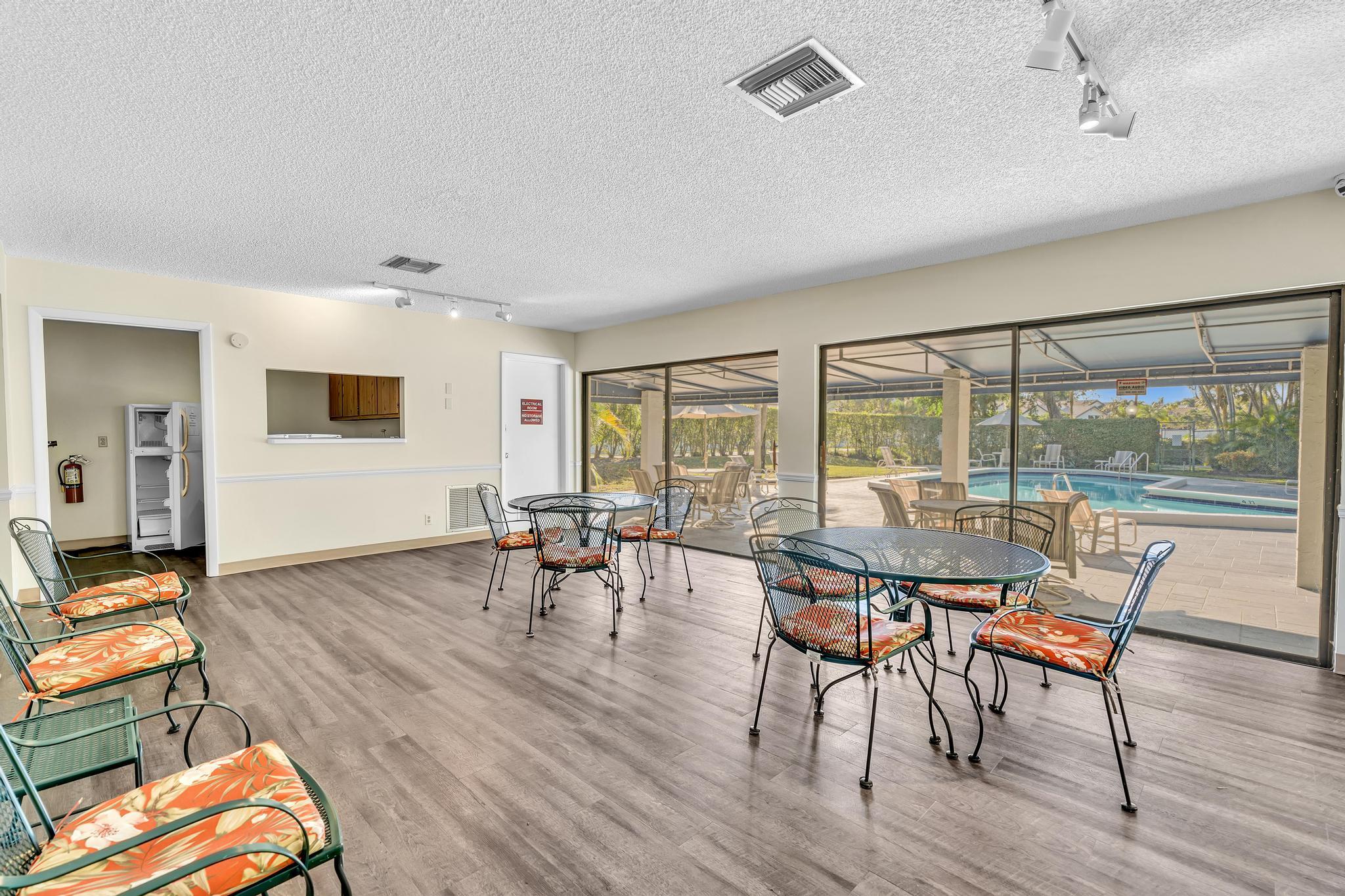 6565 Parkview Drive, Unit C Boca Raton, FL 33433 - Photo 36 of 40 a view of a dining room with furniture and wooden floor