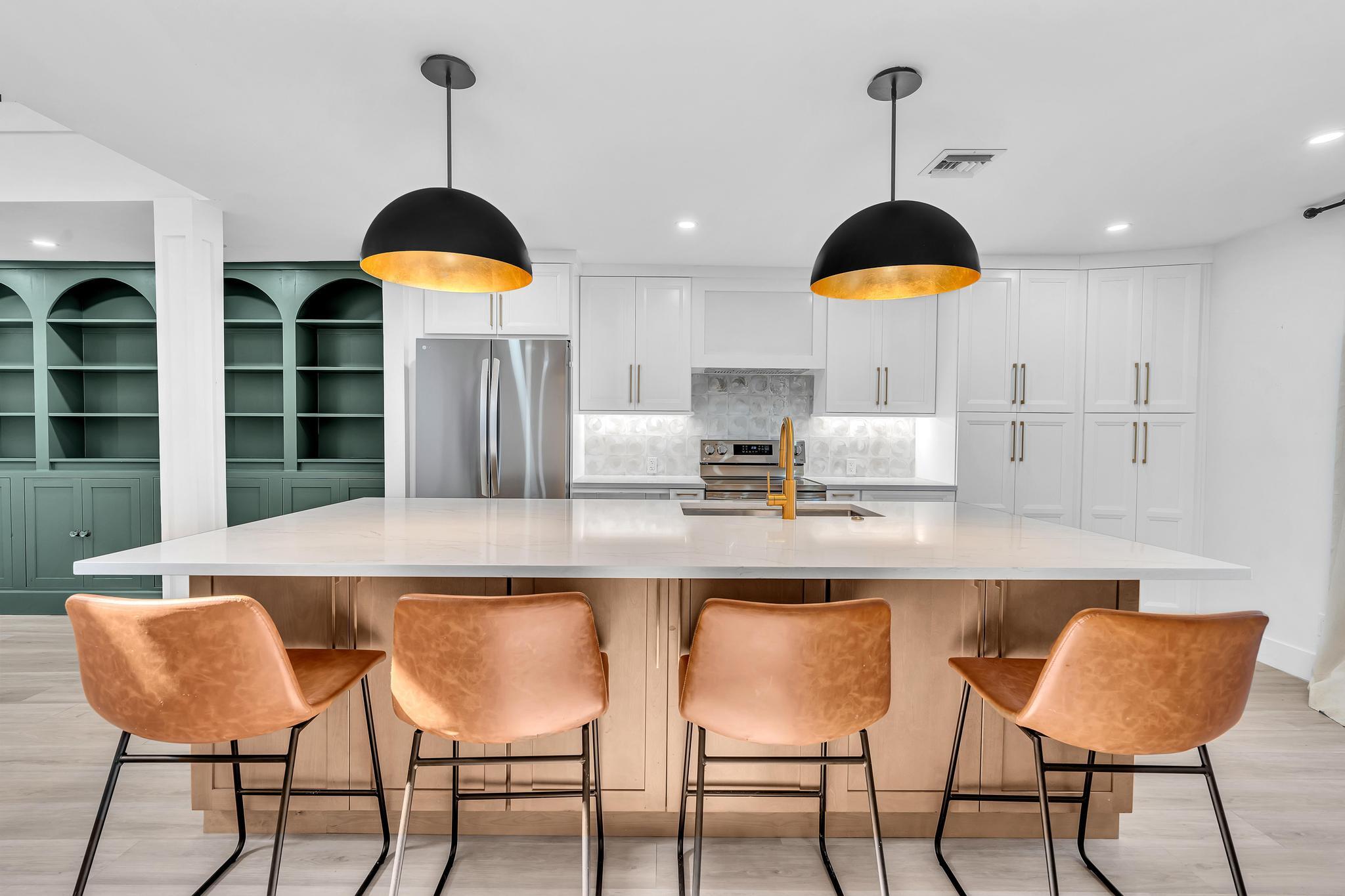 6565 Parkview Drive, Unit C Boca Raton, FL 33433 - Photo 5 of 40 a kitchen with stainless steel appliances granite countertop a dining table chairs and white cabinets