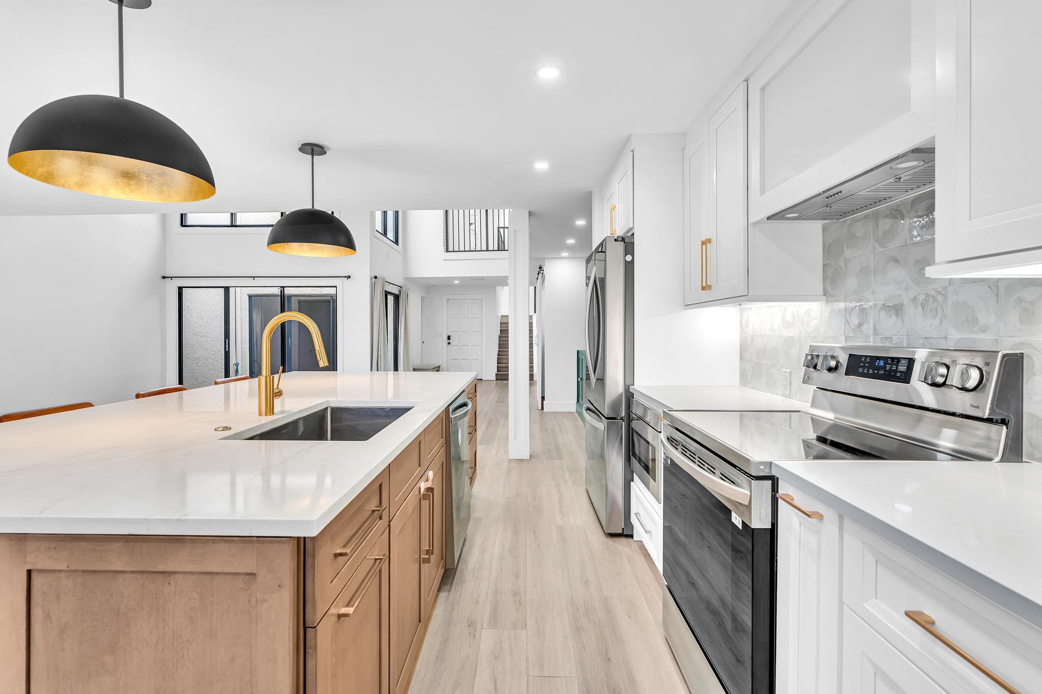 6565 Parkview Drive, Unit C Boca Raton, FL 33433 - Photo 6 of 40 a kitchen with stainless steel appliances granite countertop a sink a stove and a refrigerator