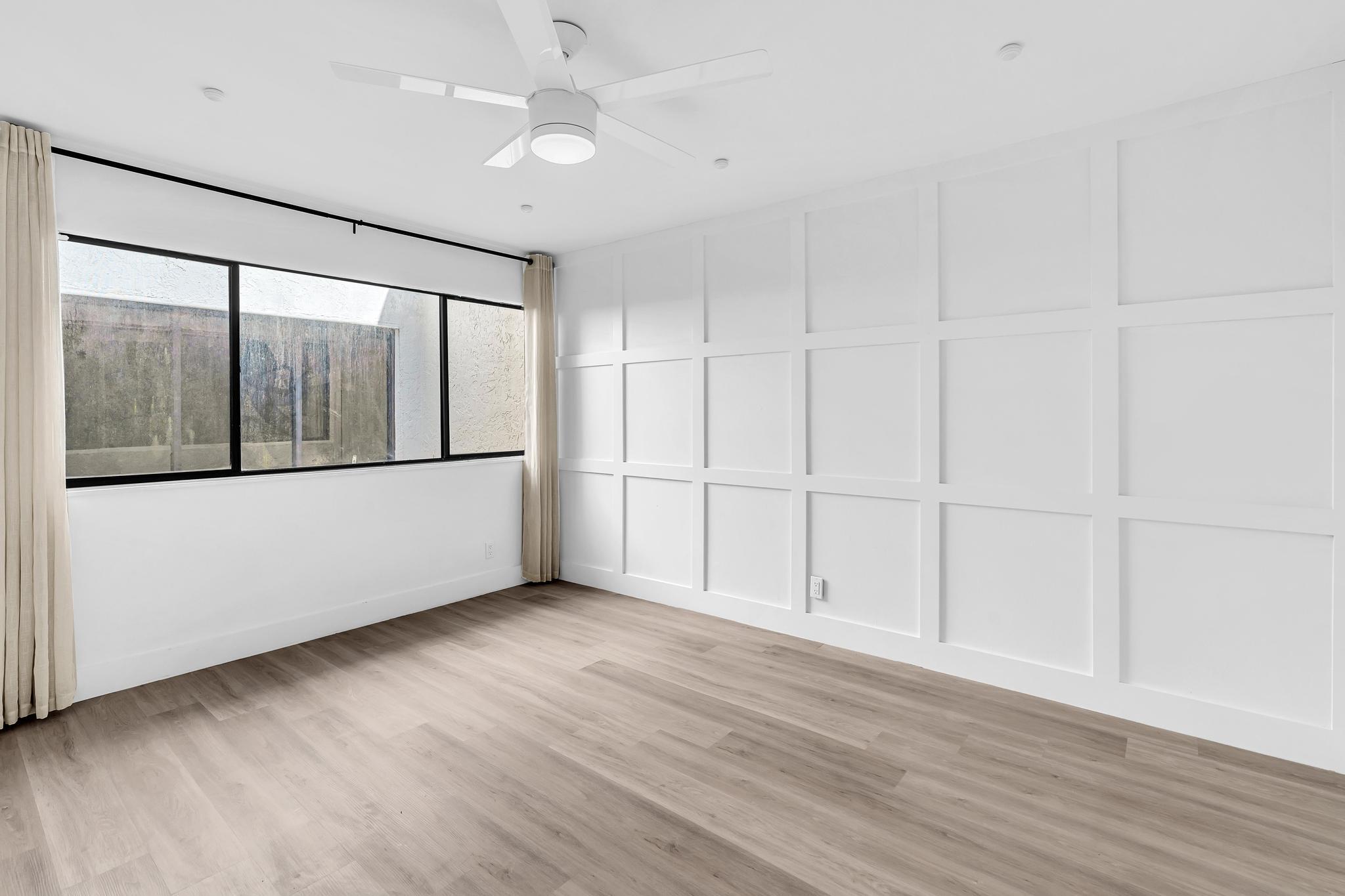 6565 Parkview Drive, Unit C Boca Raton, FL 33433 - Photo 10 of 40 an empty room with wooden floor and windows