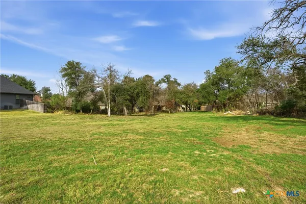 a view of outdoor space with green field and trees all around