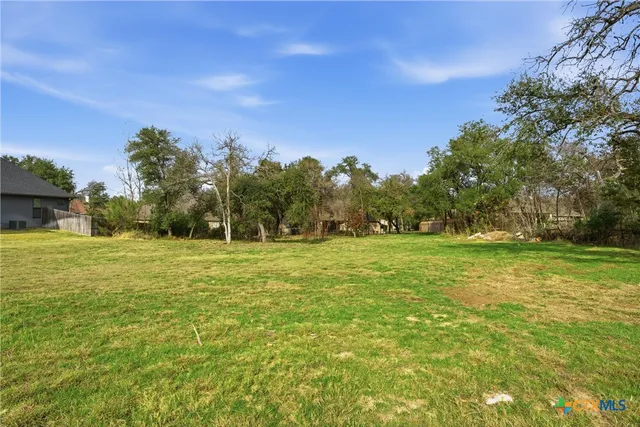 a view of outdoor space with green field and trees all around