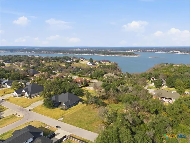 an aerial view of residential building and lake