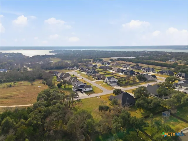 an aerial view of residential building and lake