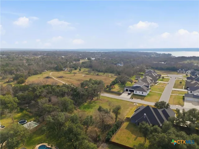 an aerial view of residential houses with outdoor space and swimming pool