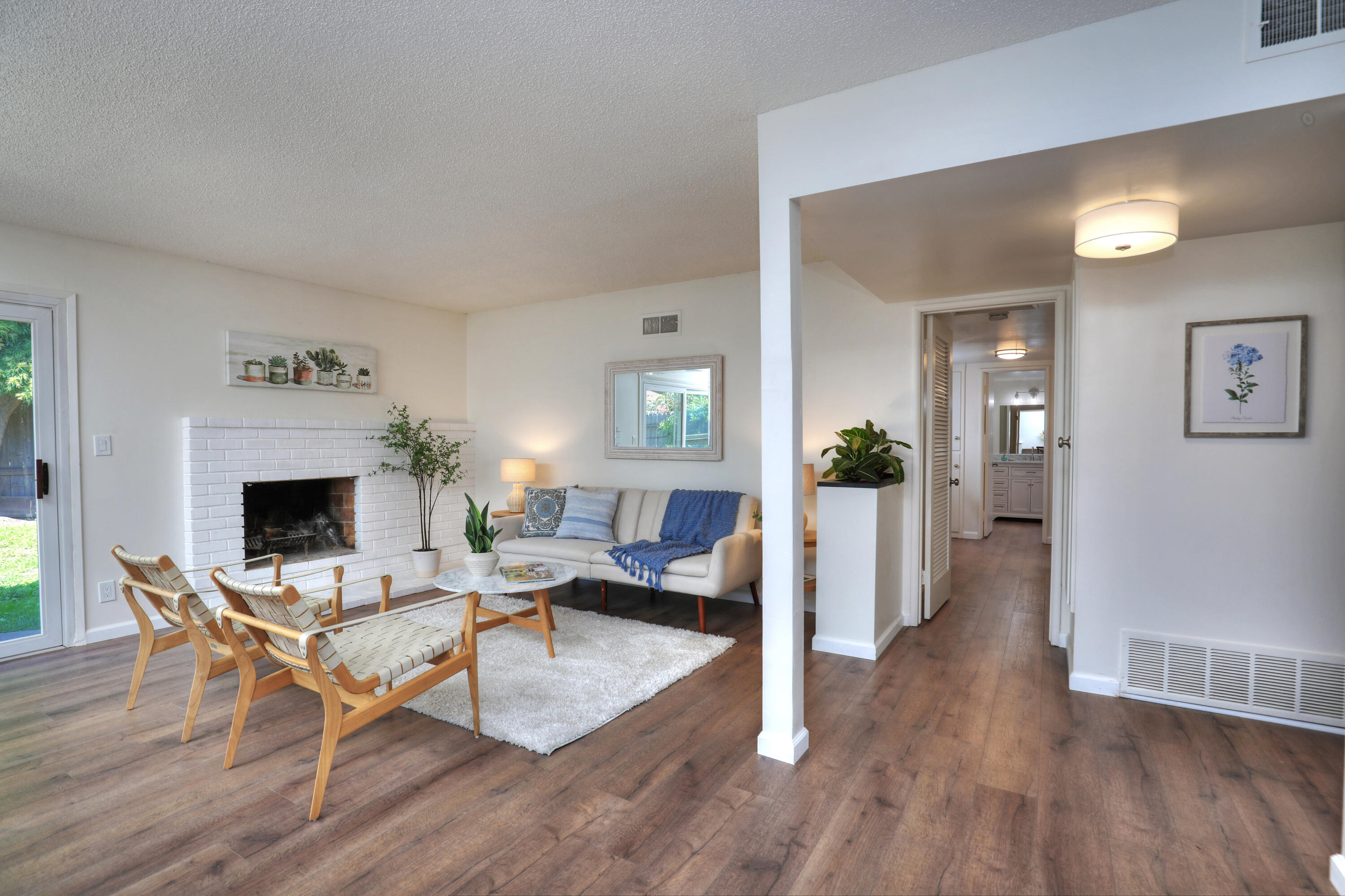 3704 Capri Drive Santa Barbara, CA 93105 - Photo 12 of 33 a living room with furniture a fireplace and a table