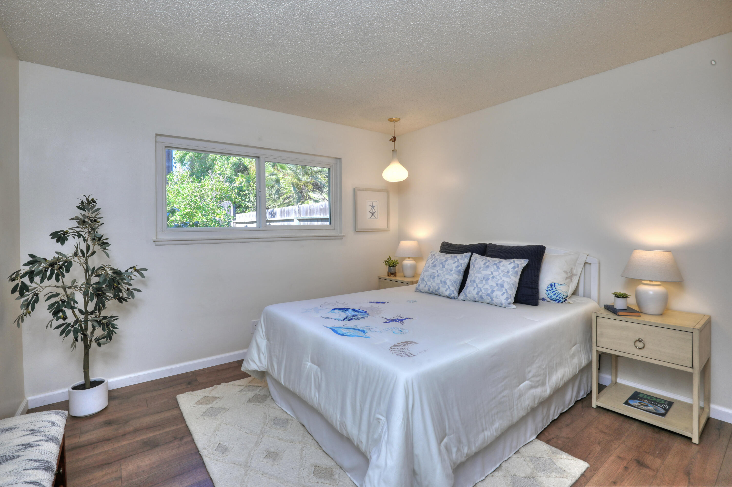 3704 Capri Drive Santa Barbara, CA 93105 - Photo 28 of 33 a bedroom with a bed and a potted plant