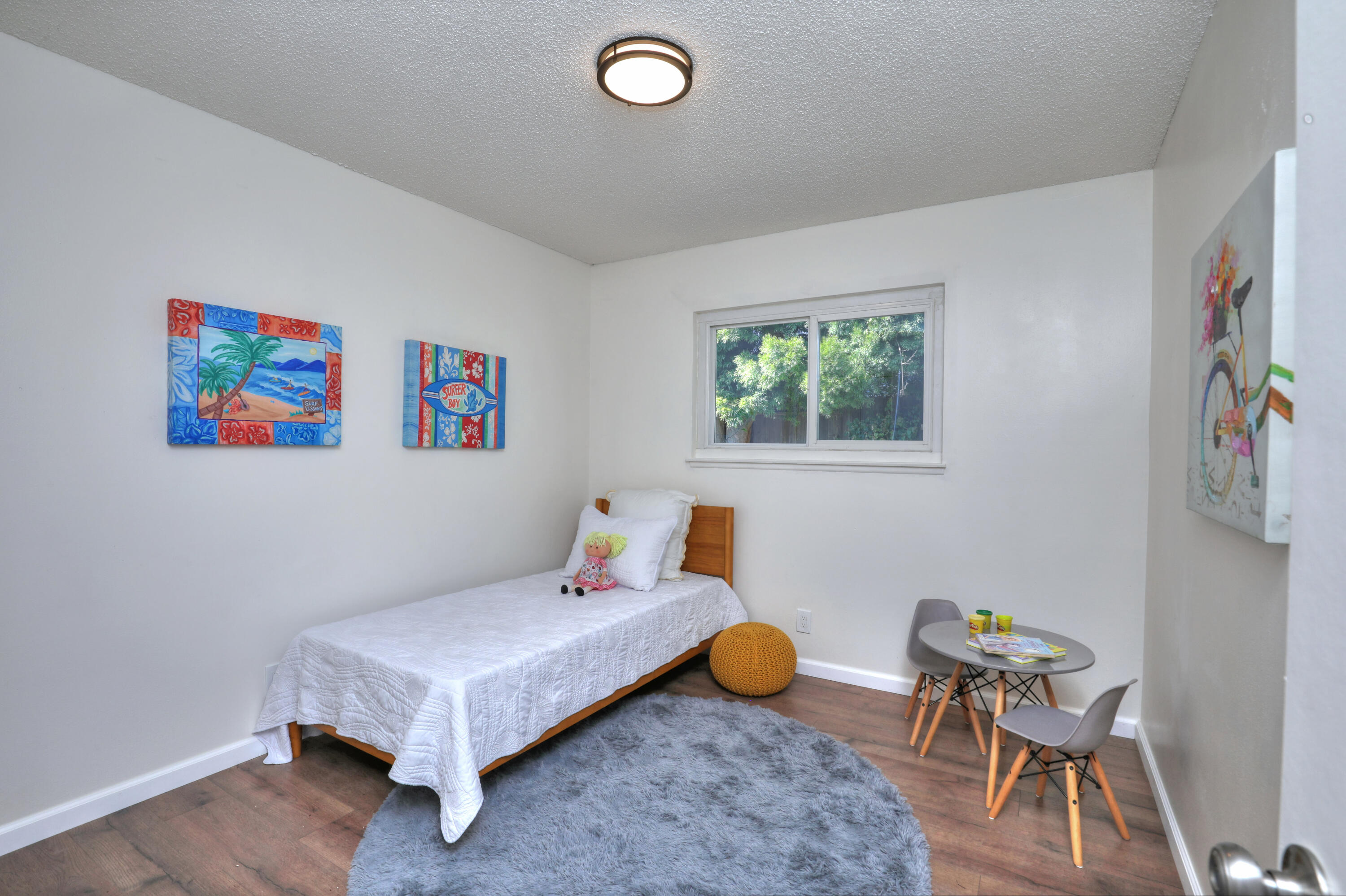 3704 Capri Drive Santa Barbara, CA 93105 - Photo 29 of 33 a living room with furniture and a baby crib next to a window