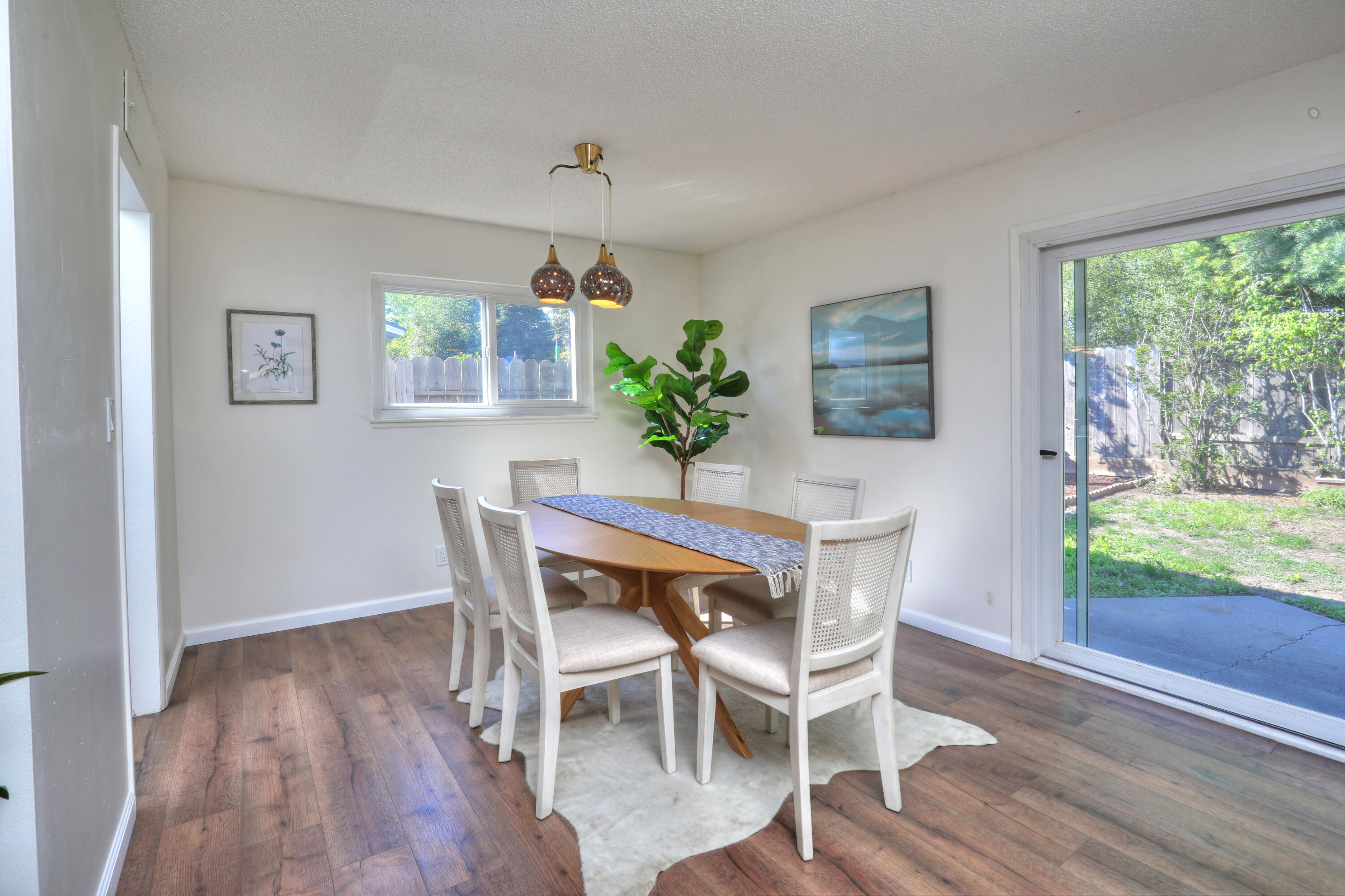 3704 Capri Drive Santa Barbara, CA 93105 - Photo 10 of 33 a dining room with furniture a large window and wooden floor