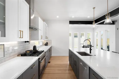 a kitchen with stainless steel appliances a sink stove and cabinets