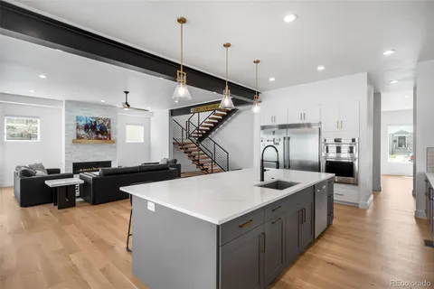 a kitchen with sink refrigerator and stove