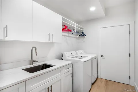 a utility room with sink dryer and washer