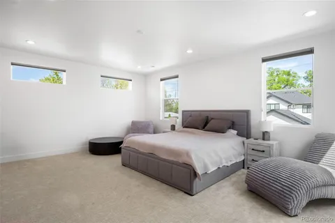 a spacious bedroom with a bed and a couch