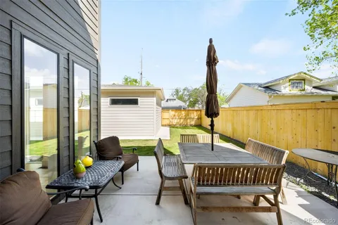a balcony with table and chairs