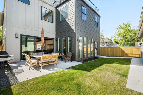 a swimming pool with outdoor seating and yard