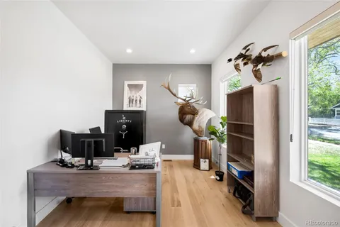 a view of a workspace with furniture and gym equipment