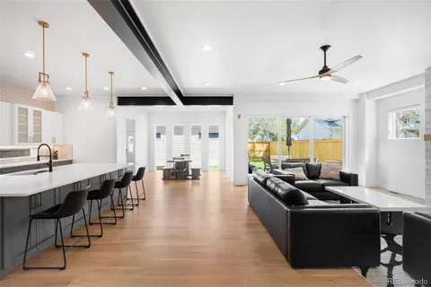 a living room with lots of furniture and a large window