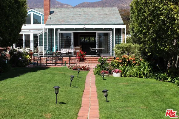 a view of a house with a garden and plants