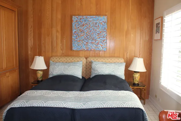 a bedroom with a bed and a lamp
