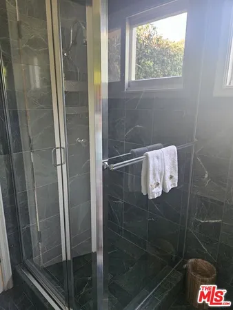 a bathroom with a glass shower door