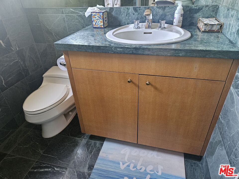30838 Broad Beach Road Malibu, CA 90265 - Photo 15 of 21 a bathroom with a granite countertop sink and a toilet