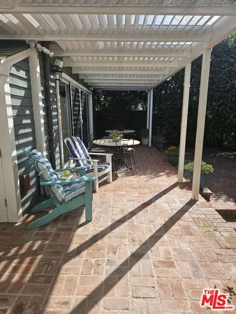 a view of a patio with a table and chairs