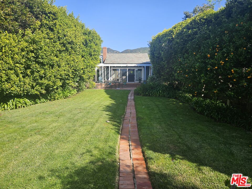 30838 Broad Beach Road Malibu, CA 90265 - Photo 4 of 21 a front view of a house with garden