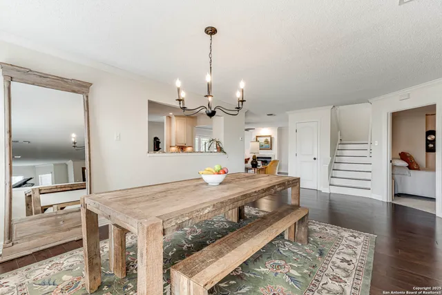 a large kitchen with kitchen island a stove a sink dishwasher and wooden floor