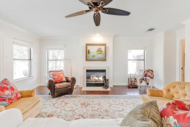 a living room with furniture fireplace and window