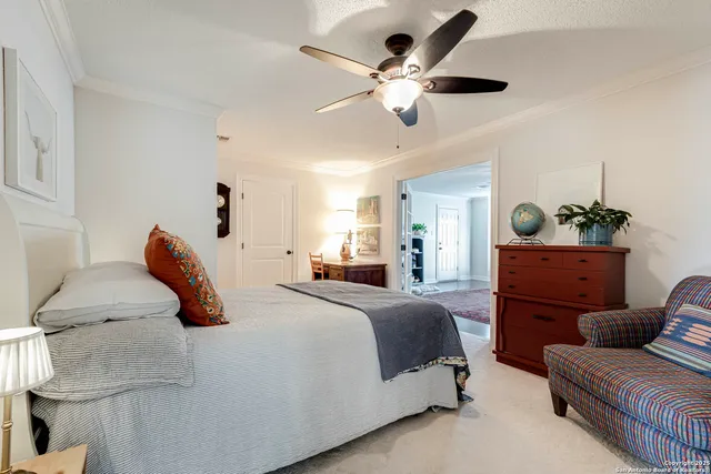 a bedroom with a bed and ceiling fan