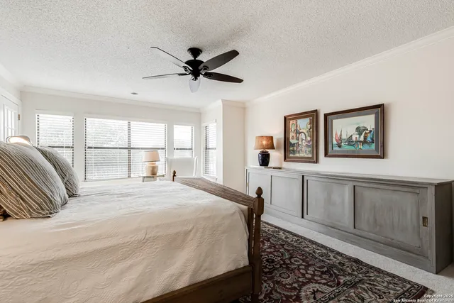 a bedroom with a large bed and a window