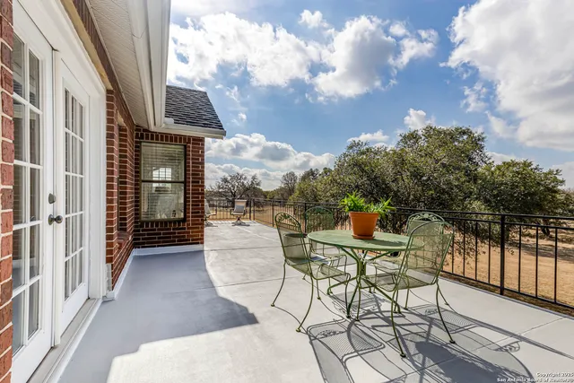 a view of a patio with a table and chairs