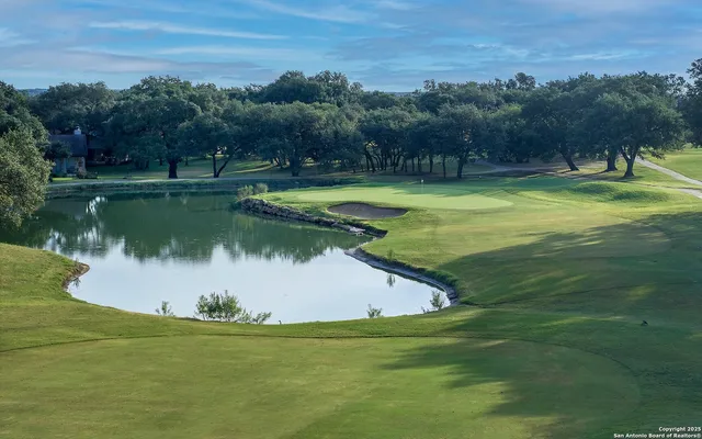 a view of a tennis ground with furniture