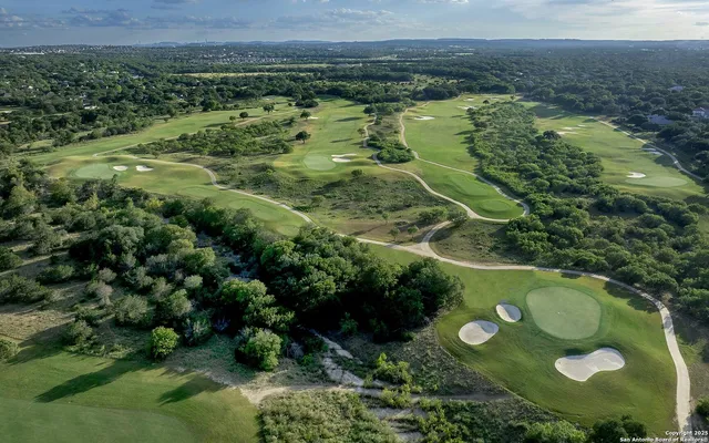 a view of a tennis ground with a swimming pool