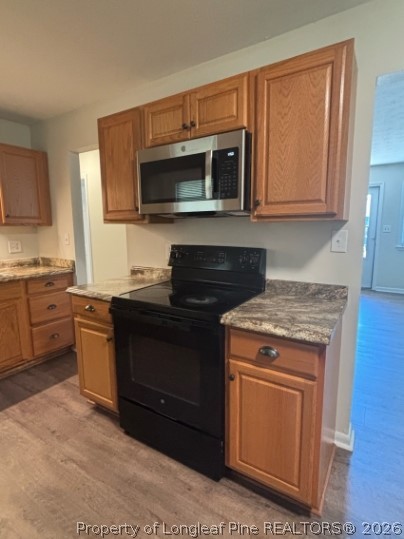 1070 Rulnick Street Fayetteville, NC 28304 - Photo 6 of 15 a kitchen with a stove microwave and sink
