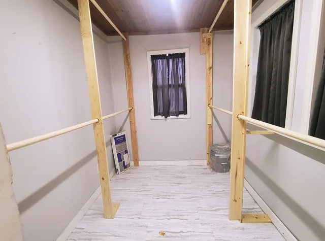 a view of an entryway with wooden floor and door