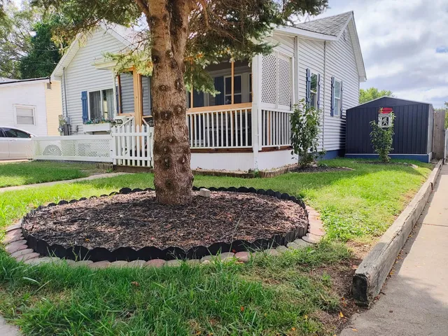 a view of a house with a yard and a garden