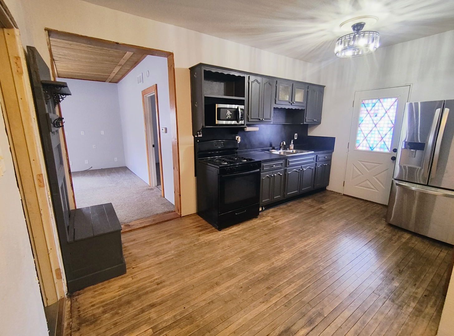 1041 West Dakota Street Spring Valley, IL 61362 - Photo 5 of 15 a kitchen with stainless steel appliances granite countertop a refrigerator a stove a sink dishwasher and a stove with wooden floor