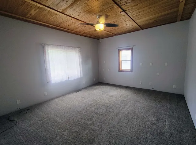 an empty room with windows and entrance