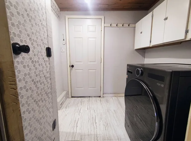 a view of bathroom with washer and dryer