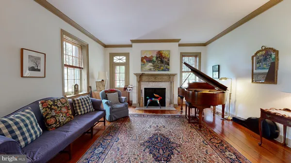 a living room with furniture and floor to ceiling windows