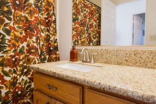 1112 Lee Avenue Ridgecrest, CA 93555 - Photo 25 of 29 a bathroom with a granite countertop sink and a mirror