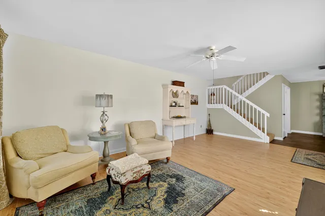 a living room with furniture and floor to ceiling windows