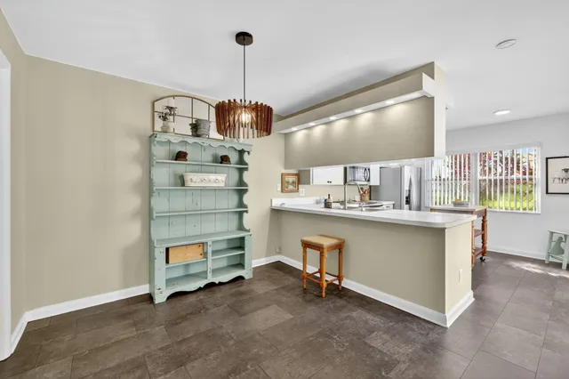 a view of a kitchen with furniture and chandelier