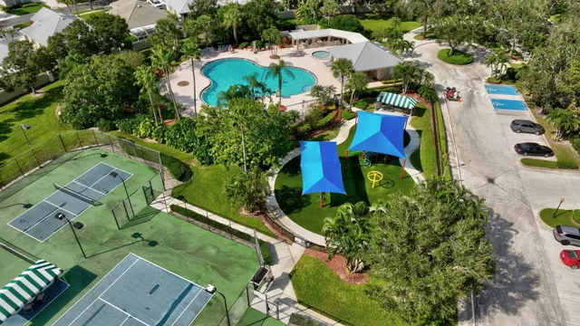 an aerial view of a residential houses with yard