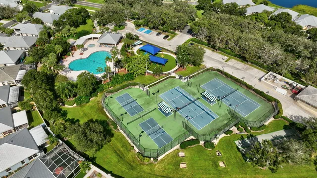 an aerial view of a multi story building with yard